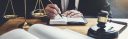 male-lawyer-or-judge-working-with-contract-papers.jpg